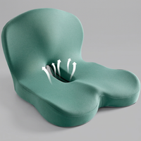 Green memory foam seat cushion with backrest, studio shot on neutral grey background